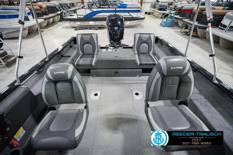 Slide: The Image of 2022 Lund 1875 Impact boat interior with four seats in a showroom. - 20