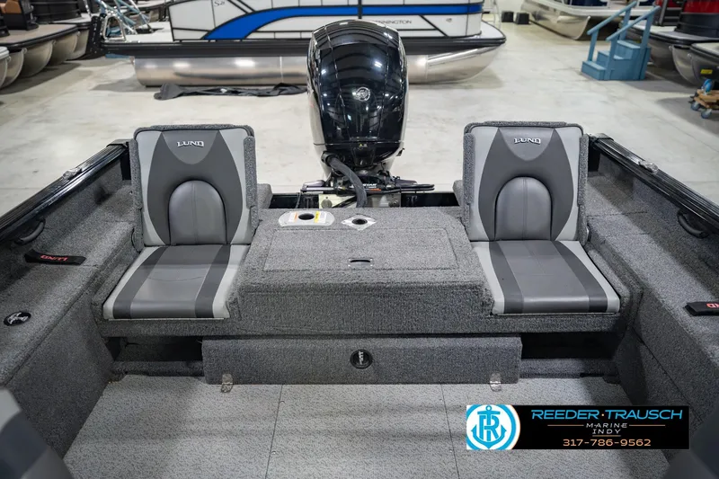 Slide: The Image of 2022 Lund 1875 Impact boat interior with dual gray seats and motor. - 21