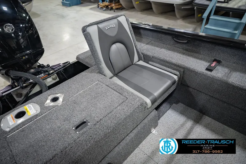 Slide: The Image of 2022 Lund 1875 Impact boat interior with gray seating and storage compartments. - 22