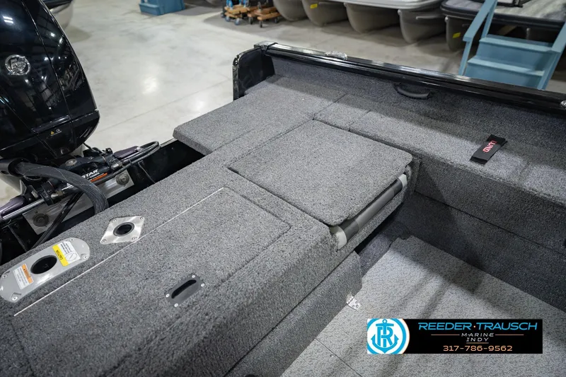 Slide: The Image of 2022 Lund 1875 Impact boat interior with carpeted deck and storage compartments. - 23