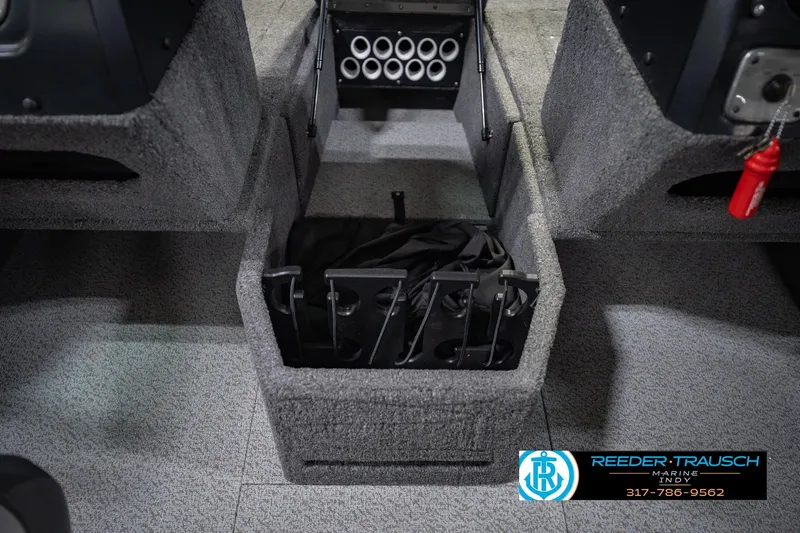 Slide: The Image of Interior storage compartment of 2022 Lund 1875 Impact boat, featuring organized rod holders. - 28
