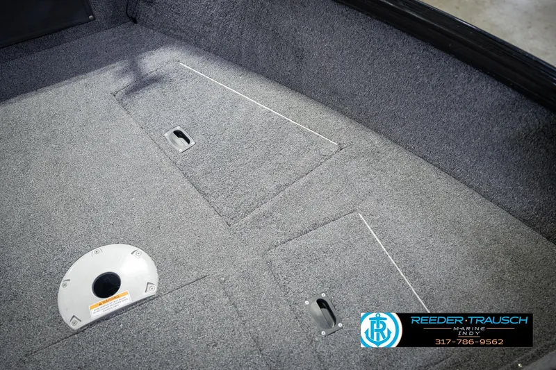 Slide: The Image of Interior view of 2022 Lund 1875 Impact boat with carpeted flooring and storage compartments. - 29