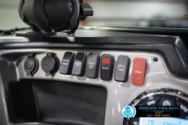Slide: The Image of Control panel of 2022 Lund 1875 Impact boat with labeled switches and dials. - 37