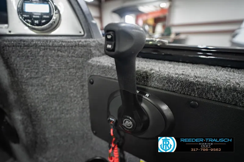 Slide: The Image of Close-up of 2022 Lund 1875 Impact boat throttle control in a showroom. - 39