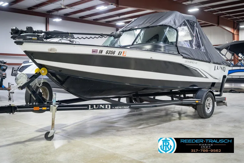 Slide: The Image of 2022 Lund 1875 Impact boat on trailer in indoor showroom. - 4
