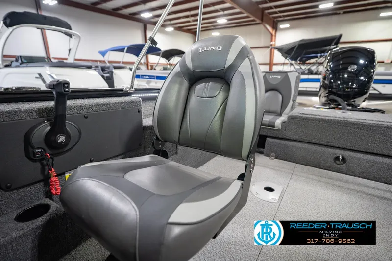 Slide: The Image of 2022 Lund 1875 Impact boat interior with seating and control panel in showroom. - 40