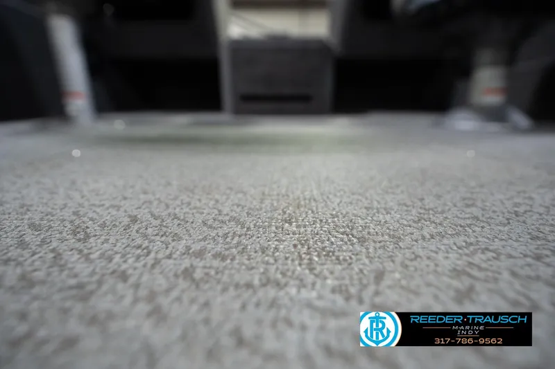 Slide: The Image of 2022 Lund 1875 Impact boat interior flooring, featuring textured surface and Reeder Trausch Marine logo. - 46