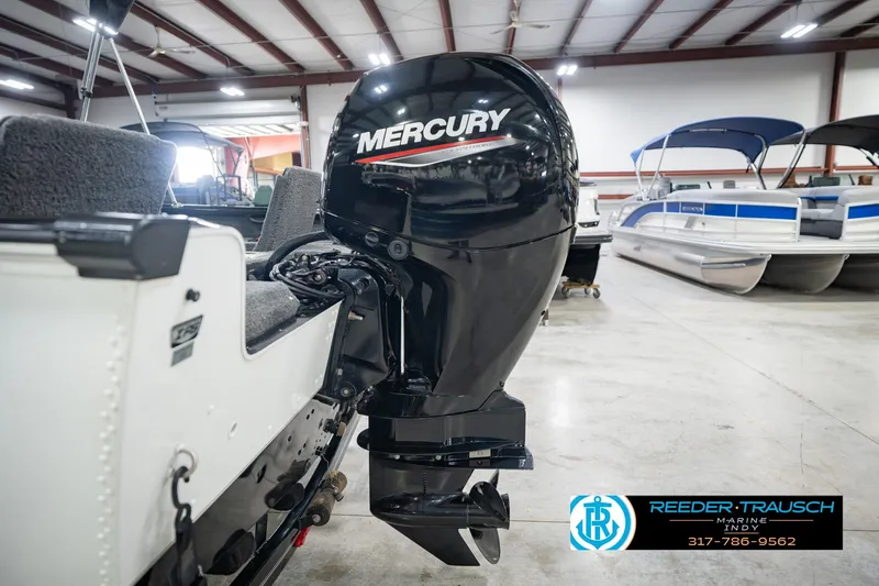 Slide: The Image of 2022 Lund 1875 Impact boat with Mercury outboard motor in showroom. - 47
