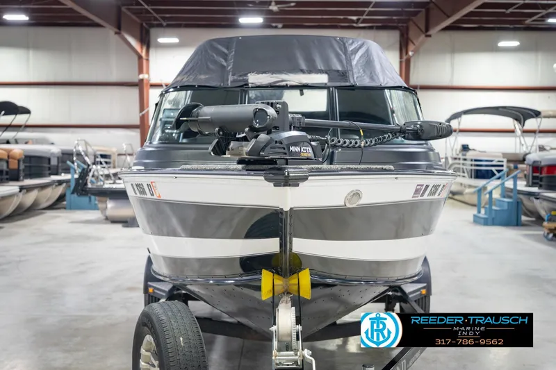 Slide: The Image of 2022 Lund 1875 Impact boat in showroom, featuring Minn Kota trolling motor. - 5