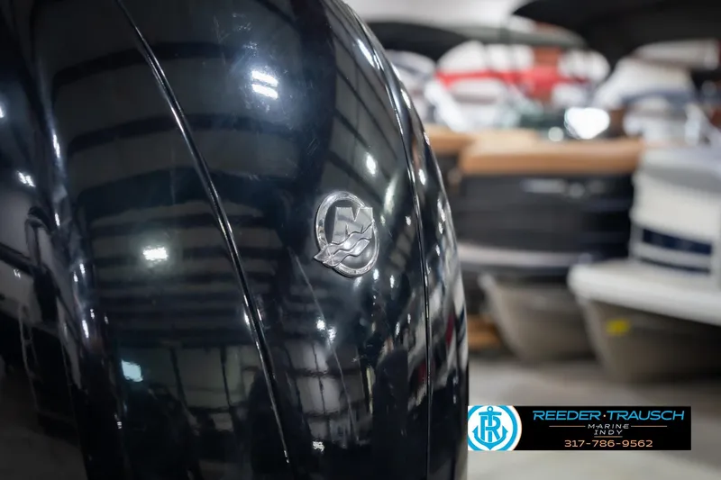 Slide: The Image of Close-up of a 2022 Lund 1875 Impact boat in a showroom setting. - 50