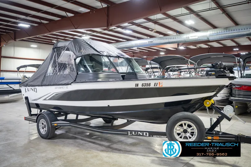 Slide: The Image of 2022 Lund 1875 Impact boat in showroom, covered and on trailer. - 6