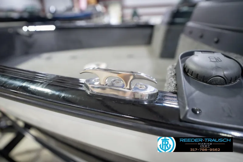 Slide: The Image of 2022 Lund 1875 Impact boat detail with cleat and fuel cap, Reeder-Trausch Marine logo visible. - 63