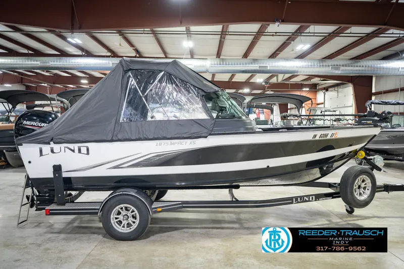 Slide: The Image of 2022 Lund 1875 Impact boat with cover on trailer in showroom. - 7