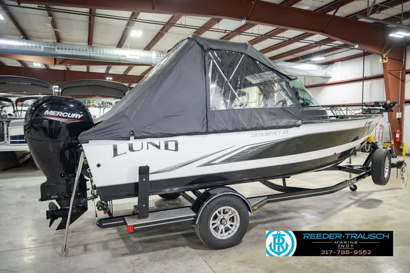 Slide: The Image of 2022 Lund 1875 Impact boat with Mercury engine in indoor showroom. - 8