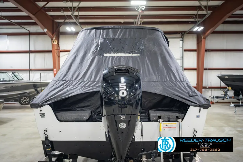 Slide: The Image of 2022 Lund 1875 Impact boat with Mercury 150 engine in indoor storage. - 9