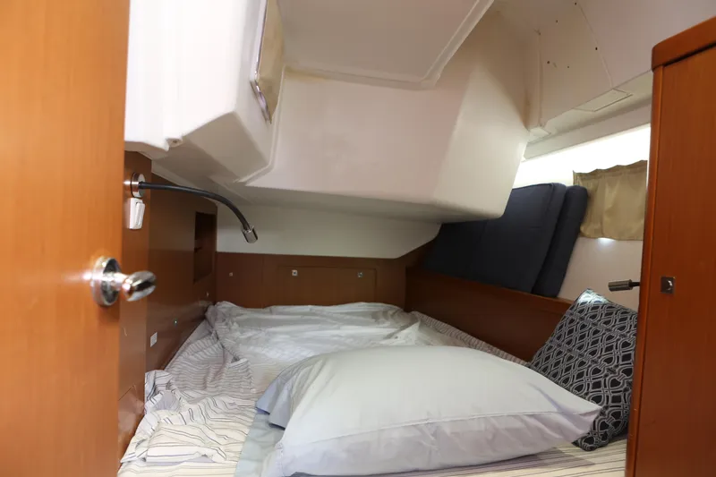 Slide: The Image of Cozy cabin interior of 2014 Beneteau Oceanis 41 sailboat with bed and pillows. - 13