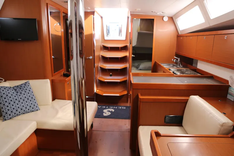 Slide: The Image of Interior of 2014 Beneteau Oceanis 41 yacht, featuring cozy seating and modern kitchen amenities. - 19