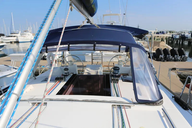 Slide: The Image of 2014 Beneteau Oceanis 41 sailboat docked at marina, featuring dual steering wheels. - 5