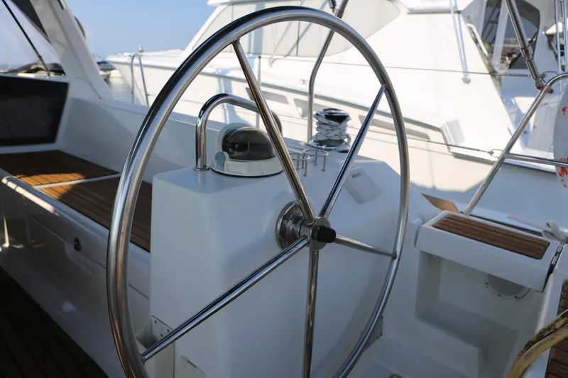 Slide: The Image of Steering wheel of a 2014 Beneteau Oceanis 41 sailboat, featuring sleek design and wooden accents. - 9