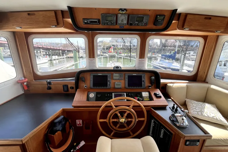 Slide: The Image of Pilothouse of 2008 Nordic Tug 42 with wooden helm and navigation equipment. - 10