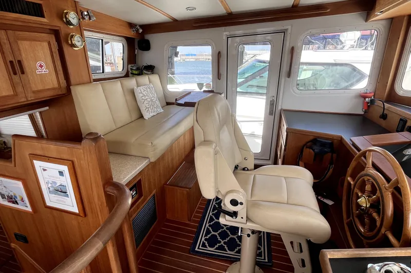 Slide: The Image of Interior of 2008 Nordic Tug 42 with helm, seating, and wooden accents. - 11