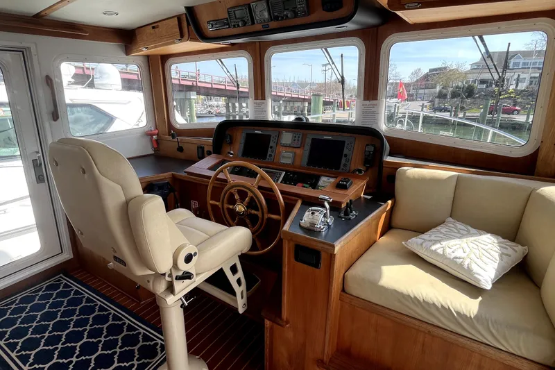 Slide: The Image of Pilothouse of 2008 Nordic Tug 42 with helm, seating, and navigation equipment. - 13