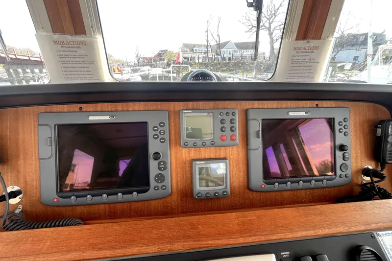 Slide: The Image of Navigation equipment on a 2008 Nordic Tug 42 boat dashboard. - 15