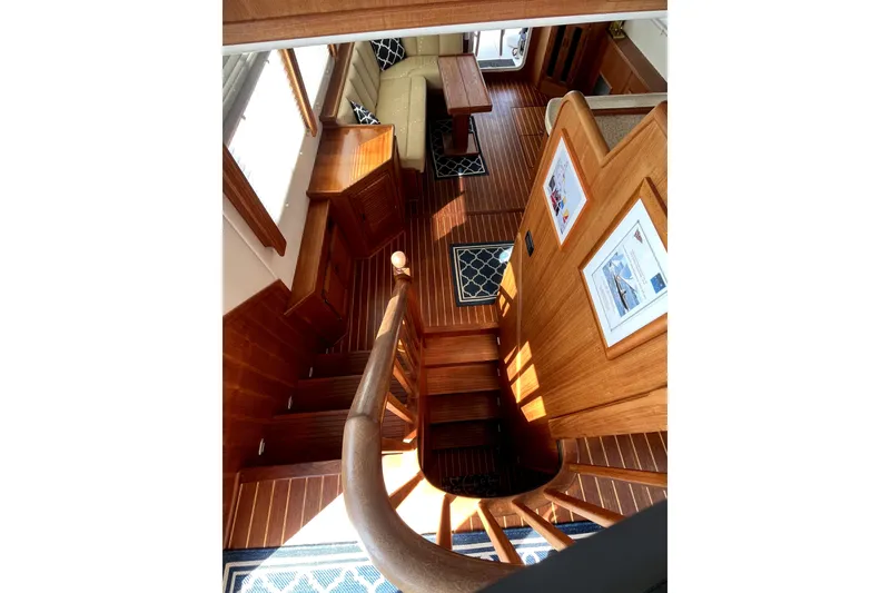 Slide: The Image of Interior of 2008 Nordic Tug 42 with wooden staircase and cozy seating area. - 18