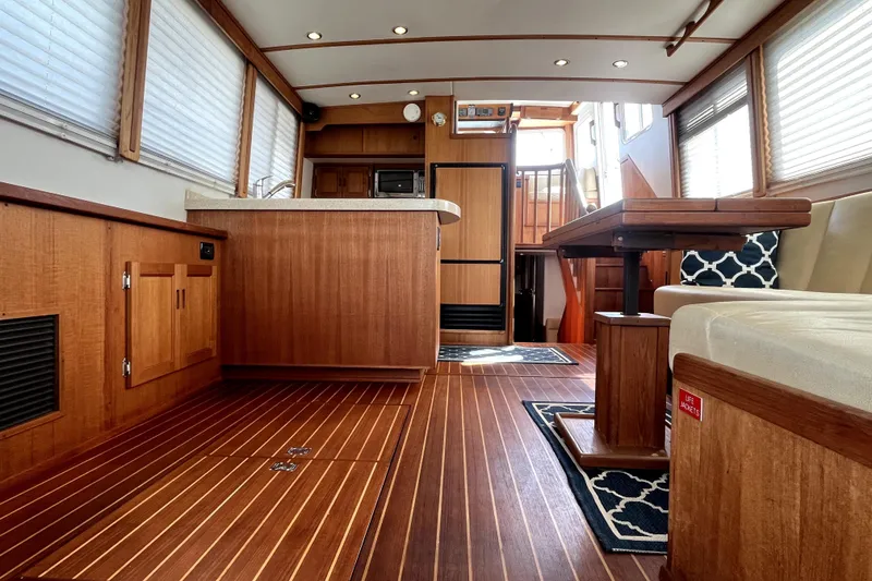 Slide: The Image of Luxurious interior of a 2008 Nordic Tug 42 yacht with wood finishes and modern amenities. - 20