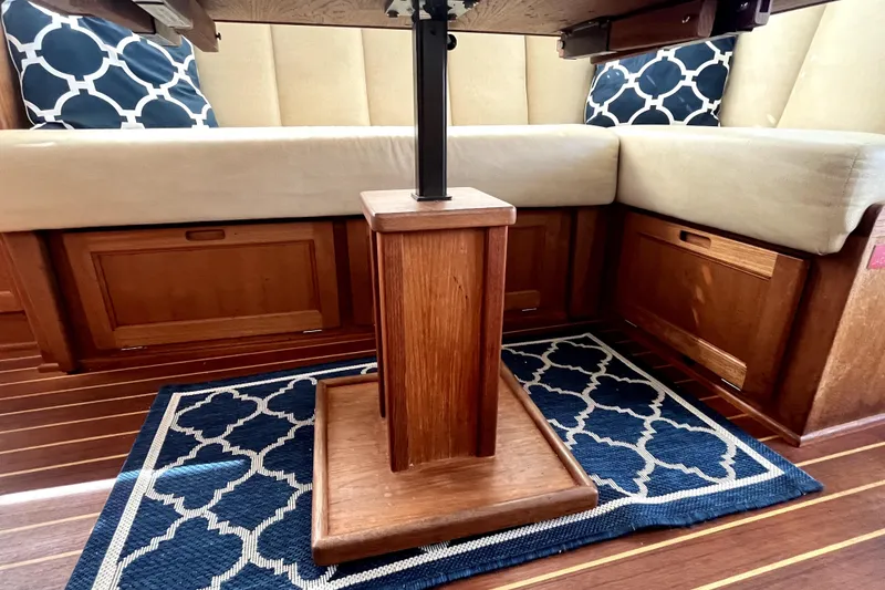 Slide: The Image of Interior of 2008 Nordic Tug 42 with wooden table, cushioned seating, and patterned rug. - 22