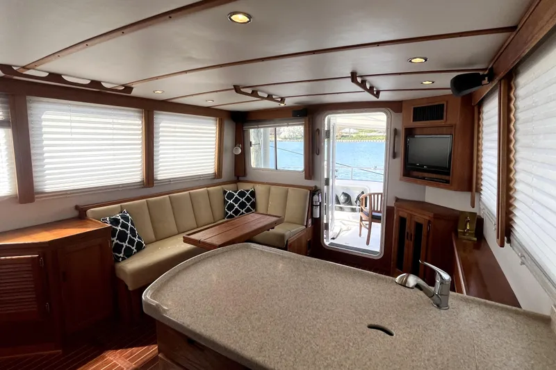 Slide: The Image of Luxurious interior of a 2008 Nordic Tug 42 yacht with elegant seating and scenic views. - 24