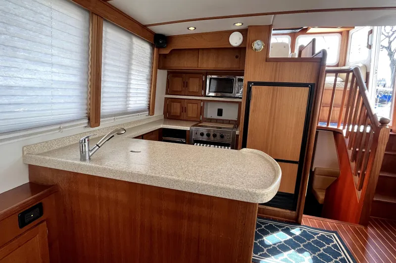 Slide: The Image of 2008 Nordic Tug 42 interior kitchen with wood cabinetry, countertop, and appliances. - 26