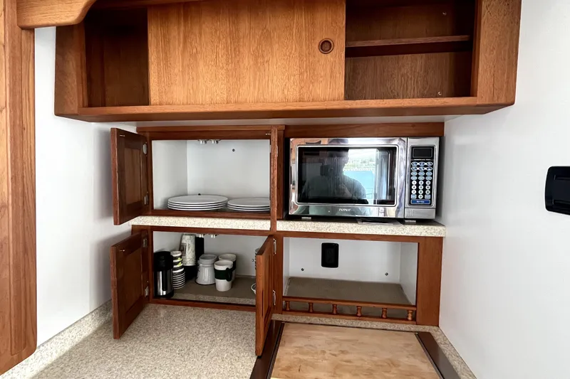Slide: The Image of Galley kitchen in 2008 Nordic Tug 42 with microwave and wooden cabinets. - 29
