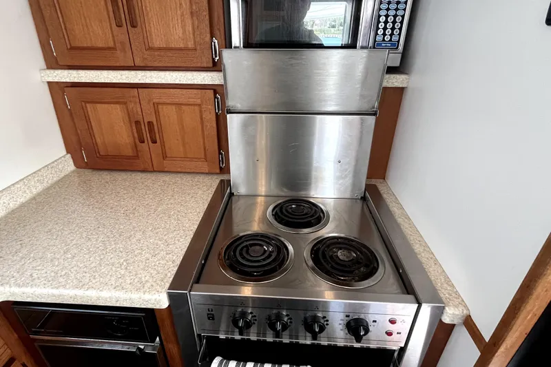 Slide: The Image of Compact kitchen area in a 2008 Nordic Tug 42, featuring a stove and microwave. - 30