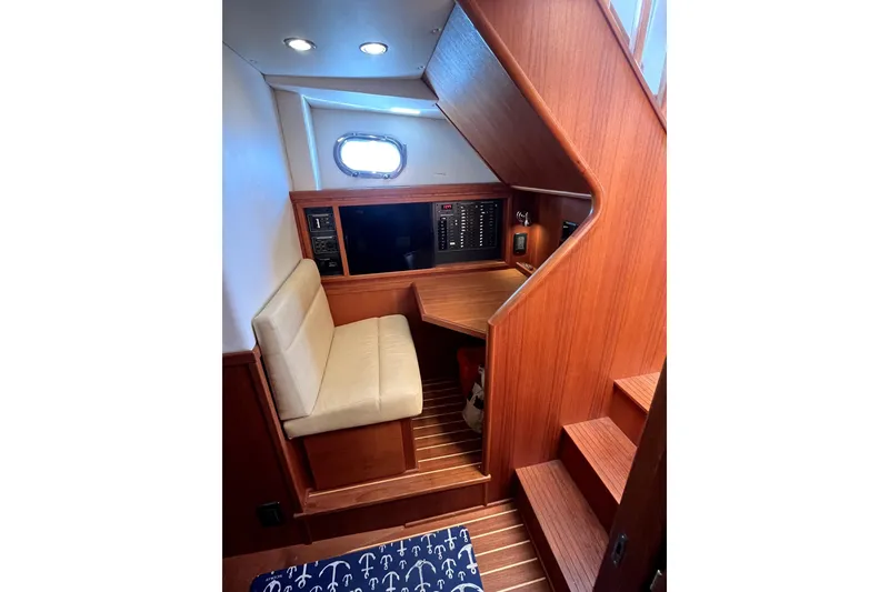 Slide: The Image of Interior of 2008 Nordic Tug 42 with wooden paneling and seating area. - 34