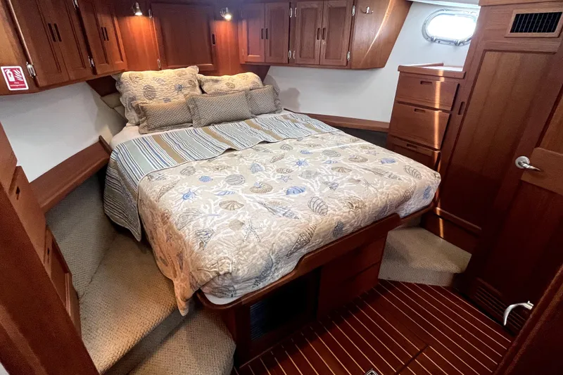 Slide: The Image of Cozy cabin interior of 2008 Nordic Tug 42 with wood cabinetry and comfortable bedding. - 35