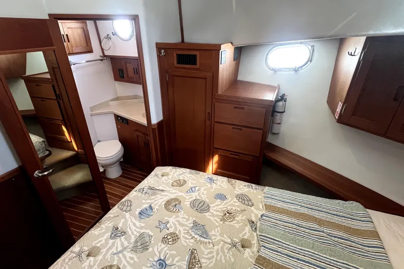 Slide: The Image of Cozy cabin interior of 2008 Nordic Tug 42 with bed, bathroom, and wooden cabinetry. - 36