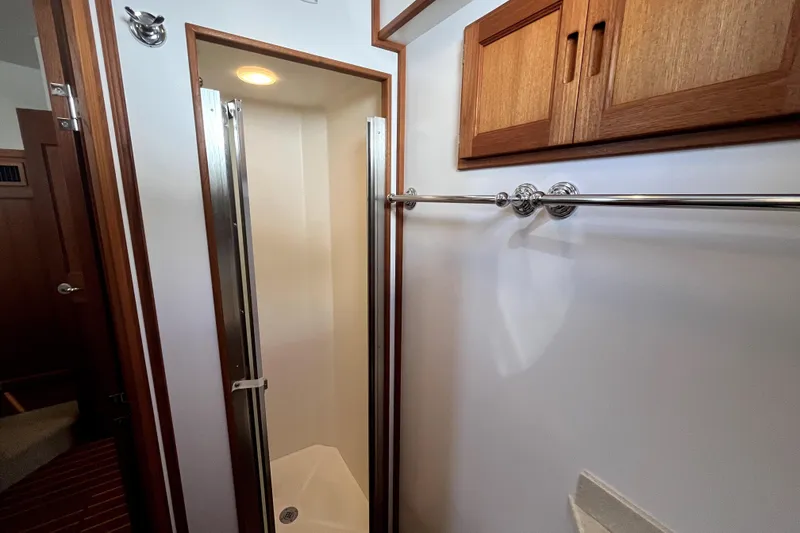 Slide: The Image of Shower area in 2008 Nordic Tug 42 boat with wooden cabinetry and chrome fixtures. - 37