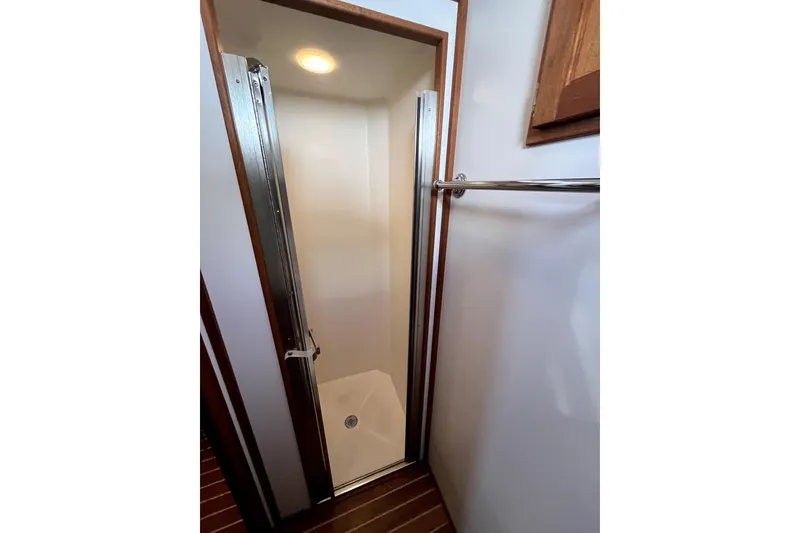 Slide: The Image of Shower area in 2008 Nordic Tug 42 boat with wooden accents and towel rack. - 38