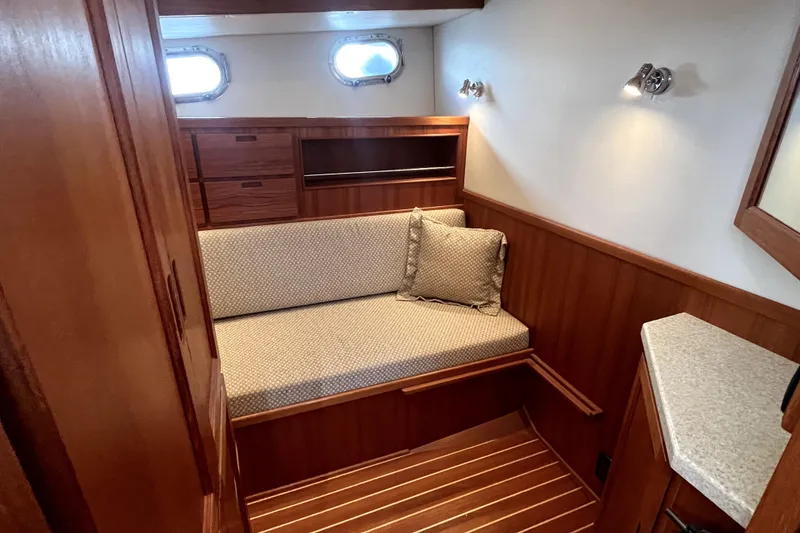 Slide: The Image of Cozy interior of 2008 Nordic Tug 42 with wooden paneling and cushioned seating. - 40