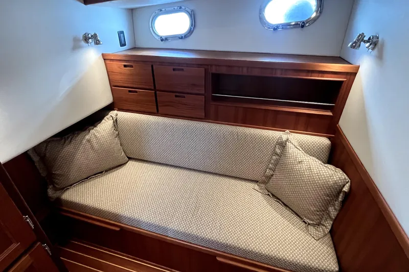 Slide: The Image of Cozy cabin interior of 2008 Nordic Tug 42 with cushioned seating and wooden storage. - 41