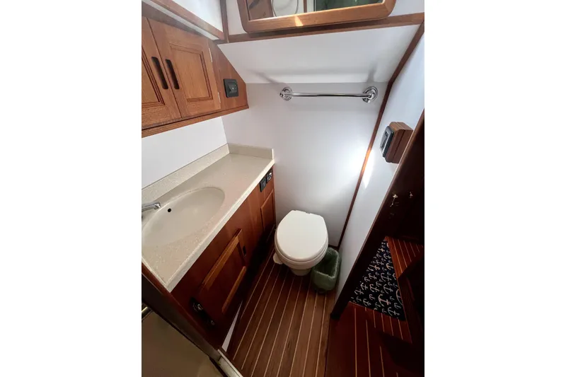 Slide: The Image of Bathroom interior of 2008 Nordic Tug 42 with wooden cabinetry and modern fixtures. - 42