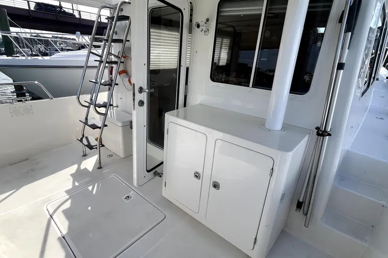 Slide: The Image of 2008 Nordic Tug 42 boat deck with ladder, door, and storage cabinet. - 44