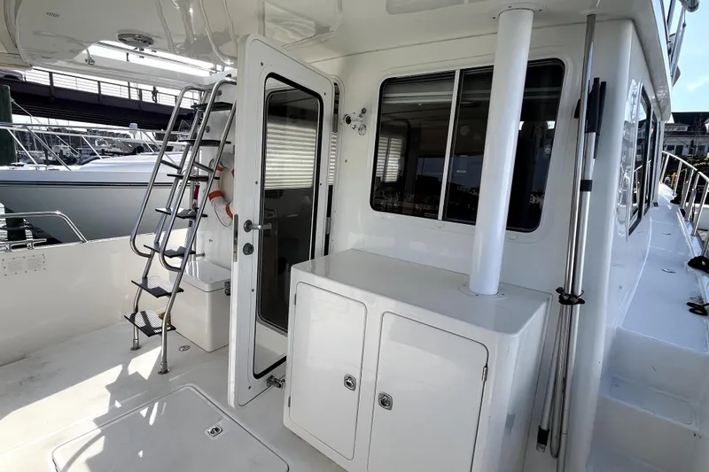 Slide: The Image of 2008 Nordic Tug 42 yacht deck with ladder and door, showcasing sleek design and functionality. - 45