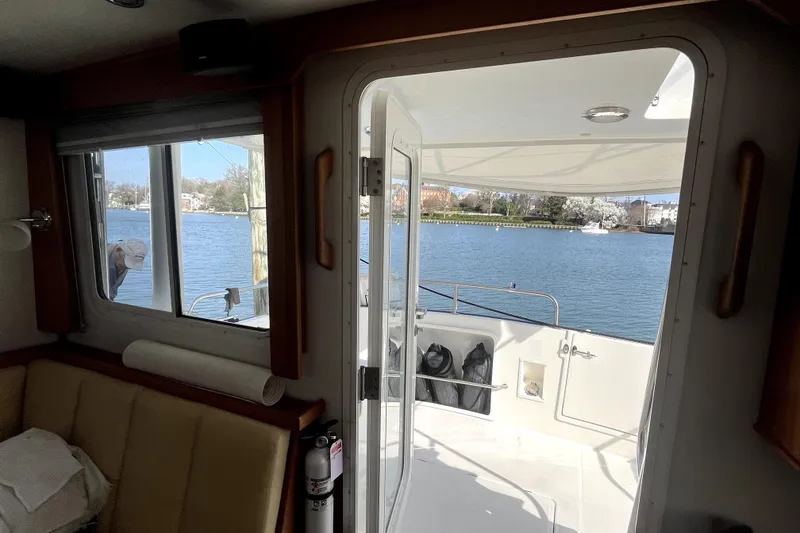 Slide: The Image of Interior view of a 2008 Nordic Tug 42, overlooking a serene waterfront. - 46
