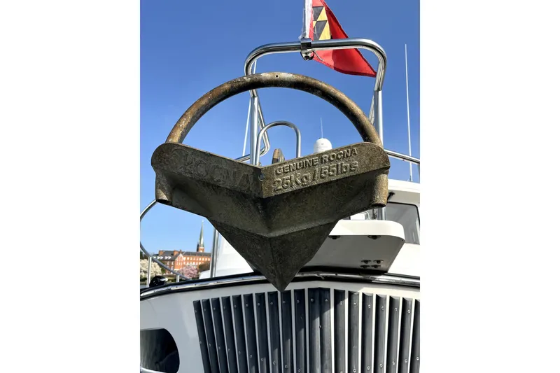 Slide: The Image of Nordic Tug 42 (2008) with anchor and flag, showcasing maritime design. - 48
