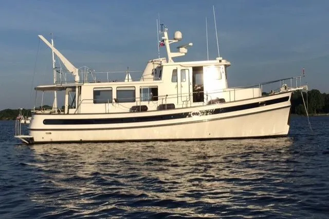 Slide: The Image of 2008 Nordic Tug 42 cruising on calm waters under a clear sky. - 5