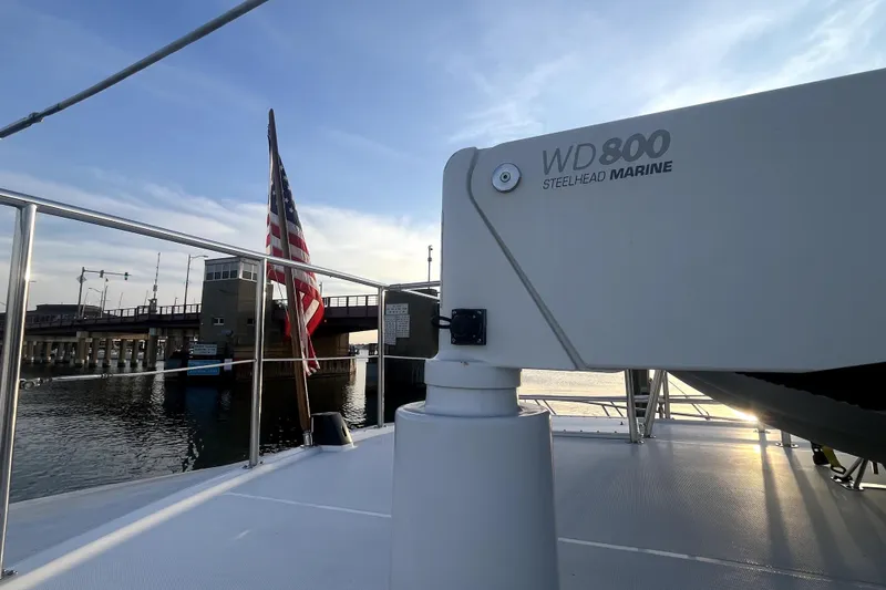Slide: The Image of Nordic Tug 42 (2008) with Steelhead Marine WD800, docked near a bridge at sunset. - 53