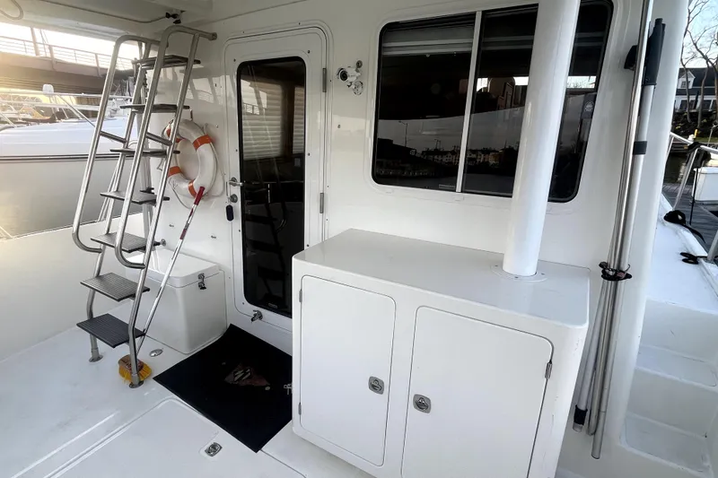 Slide: The Image of Nordic Tug 42 (2008) boat deck with ladder, door, and life preserver. - 56