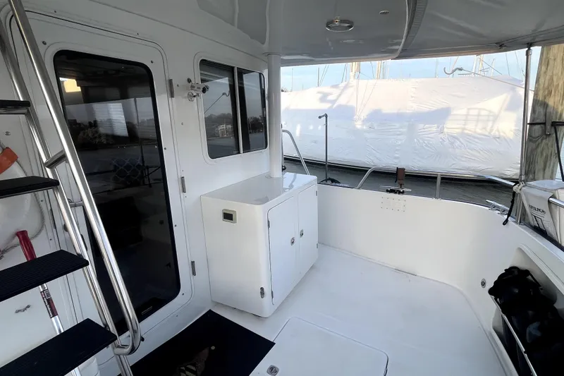 Slide: The Image of 2008 Nordic Tug 42 boat deck with white cabinetry and stainless steel railings. - 58